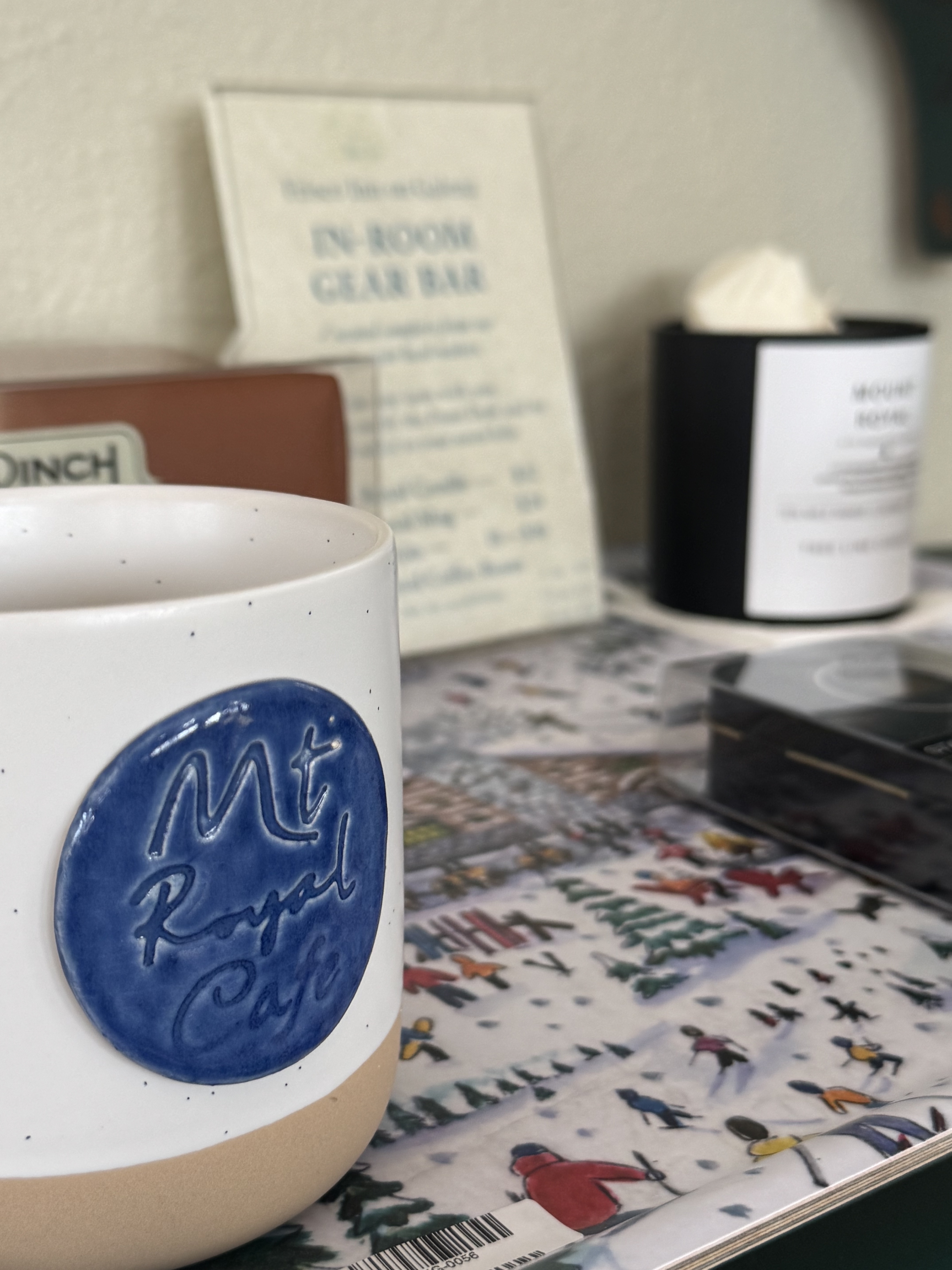 In-room gear bar tray with Mount Royal candle, mug, coffee beans, and small gifts.