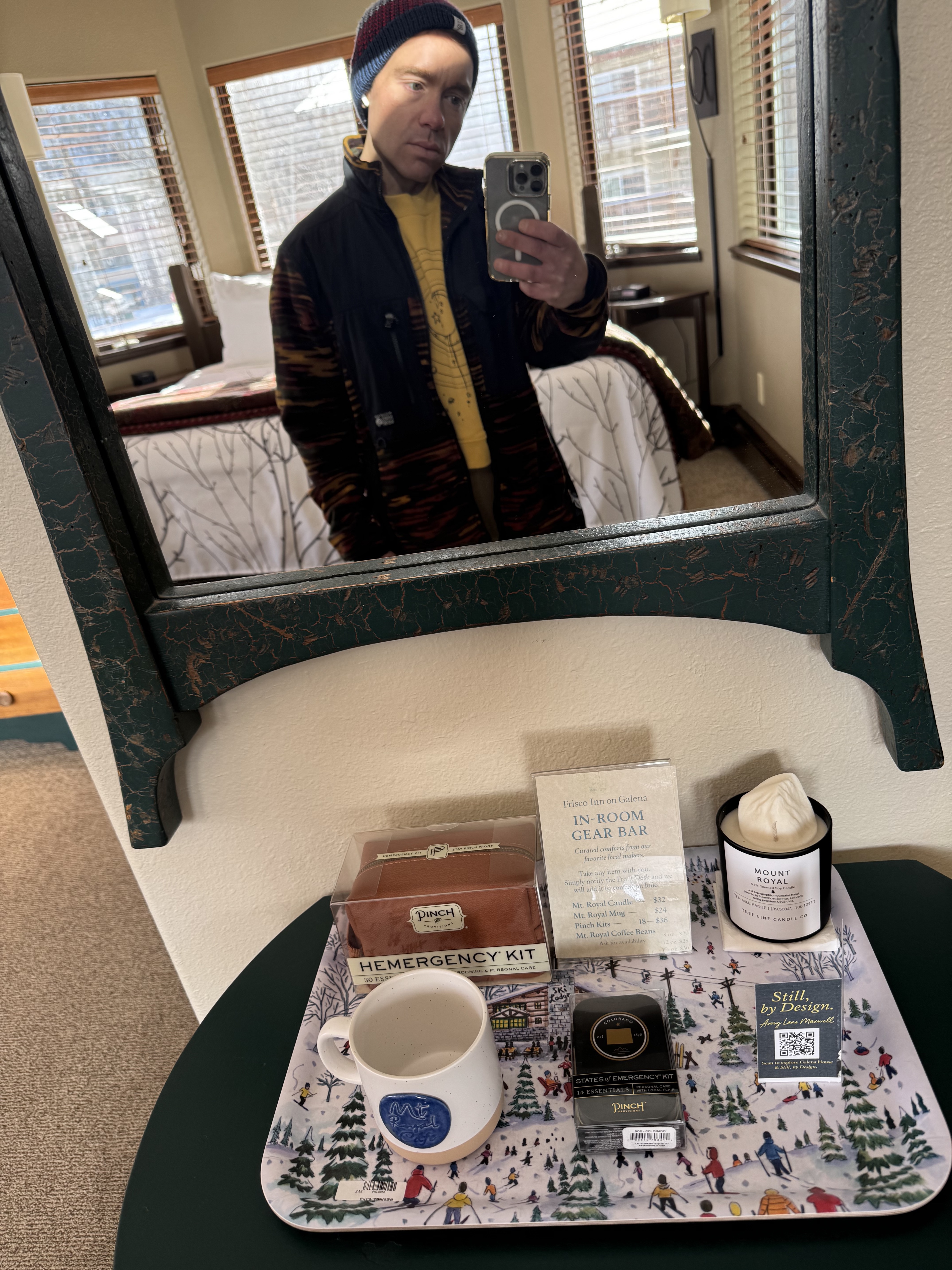In-room gear bar tray with Mount Royal candle, mug, and coffee.